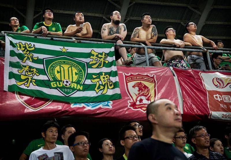Ultra supporters and fans of the Beijing Guoan FC celebrate watch their team play gainst Chongcing Lifan FC during their Chinese Super League match on June 28, 2015 in Beijing, China.