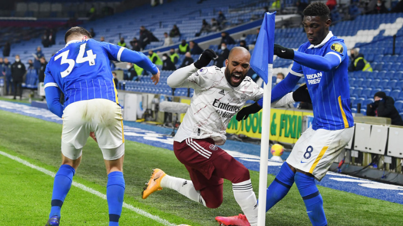 lex Lacazette of Arsenal fouled by Yves Bissouma of Brighton & HA during the Premier League match between Brighton & Hove Albion and Arsenal at American Express Community Stadium on December 29, 2020 in Brighton, England.