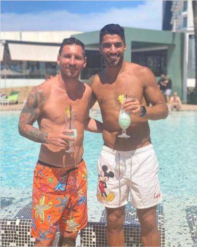 Banned from Barcelona training but cocktails still flowing for Messi and buddy Suarez